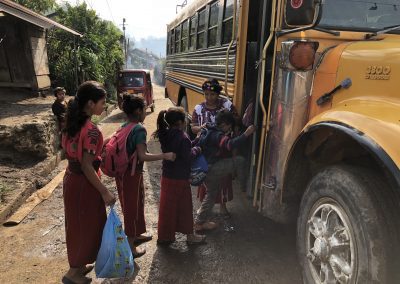 young kids in Guatemala loading the schoolbus in Chajul