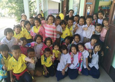 a group of students and O-Nut is pictured front and center, next to the girl in the pink jacket at Kok Khong school