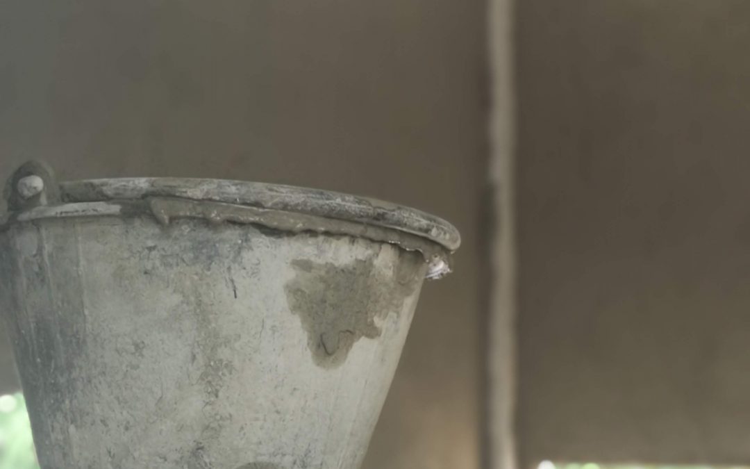 close up of a cement pail on a shelf