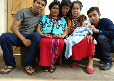 Juana and her family sit together in their new kitchen