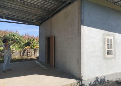 photo of nuans new house, simple cement with door and window