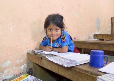 guatemalan girl at school desk with notebook