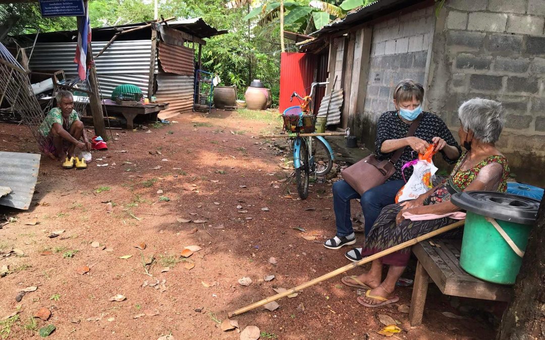 outside the home of an elder in poverty in rural thailand