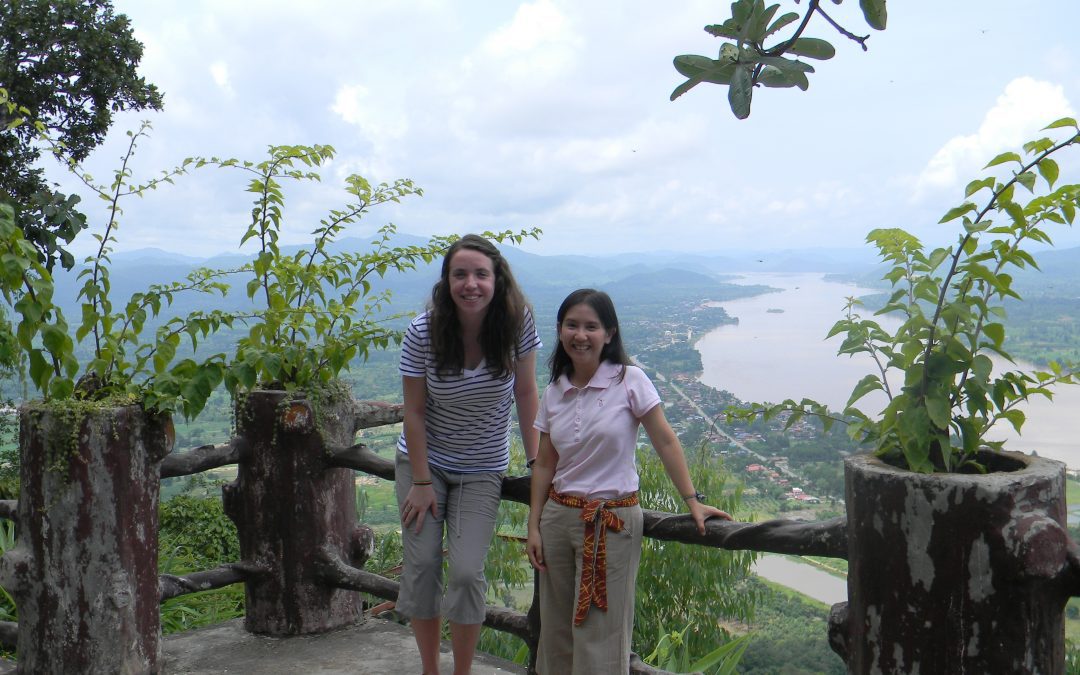 Annie stands at a lookout with young Thai girl