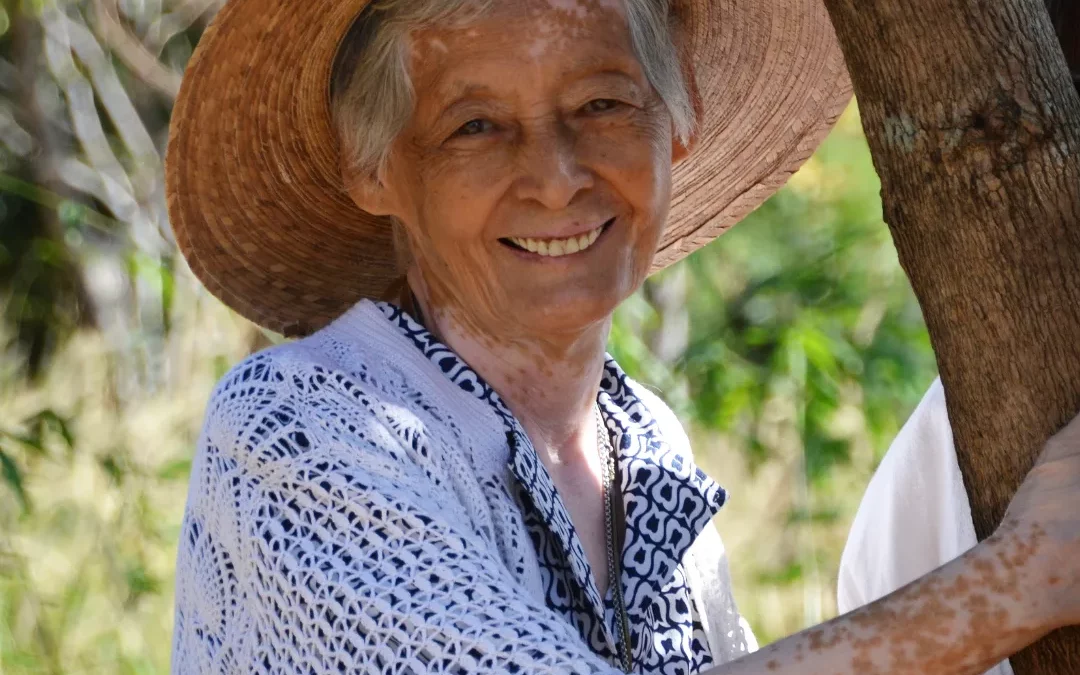 vanida in her a later years with a hat and a smile